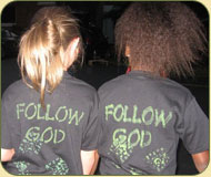 Two girl wearing Follow God shirts